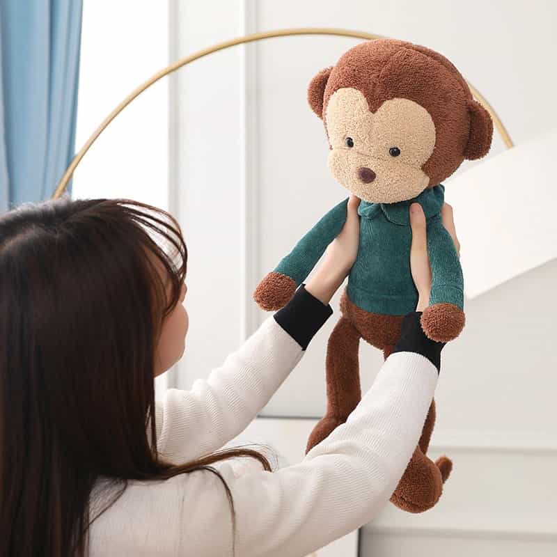 Peluche Singe Marron Tenu Dans Bras